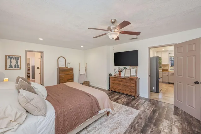 a bedroom with a bed and a flat screen tv