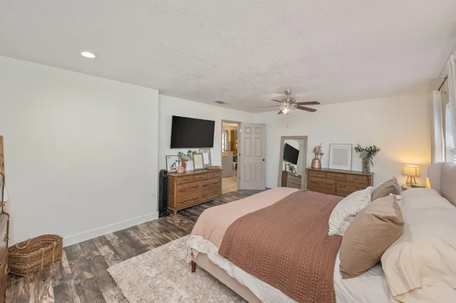 a bedroom with a bed and wooden floor