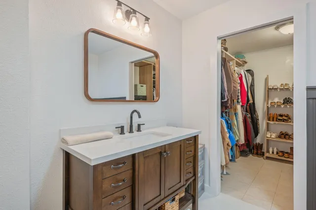 a en suite bathroom with a double vanity sink and a mirror