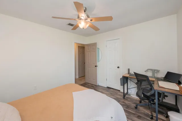 a bedroom with a bed and a chandelier