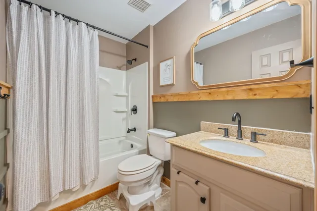 a bedroom with a bed and a book shelf