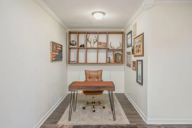 a view of an empty room with wooden floor