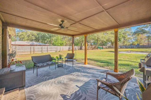 a backyard of a house with garden and swing