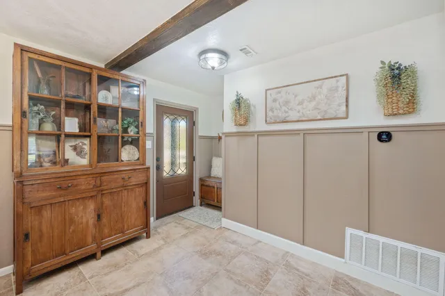 a living room with furniture and a floor to ceiling window