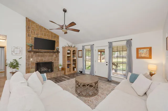 a living room with furniture and a view of kitchen