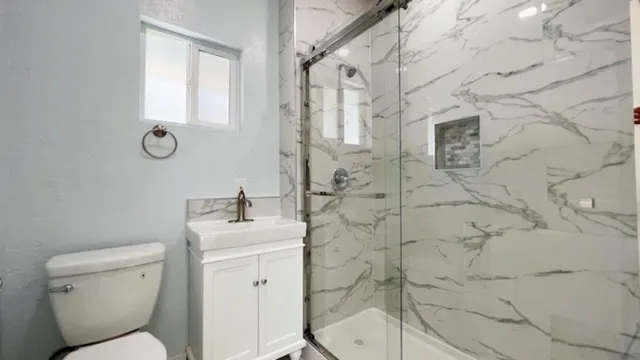 a bathroom with a sink toilet and shower