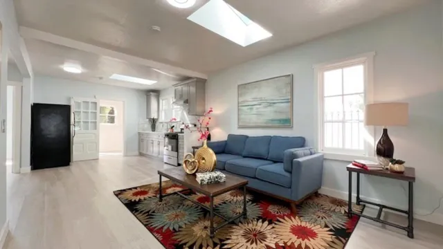 a living room with furniture rug and window