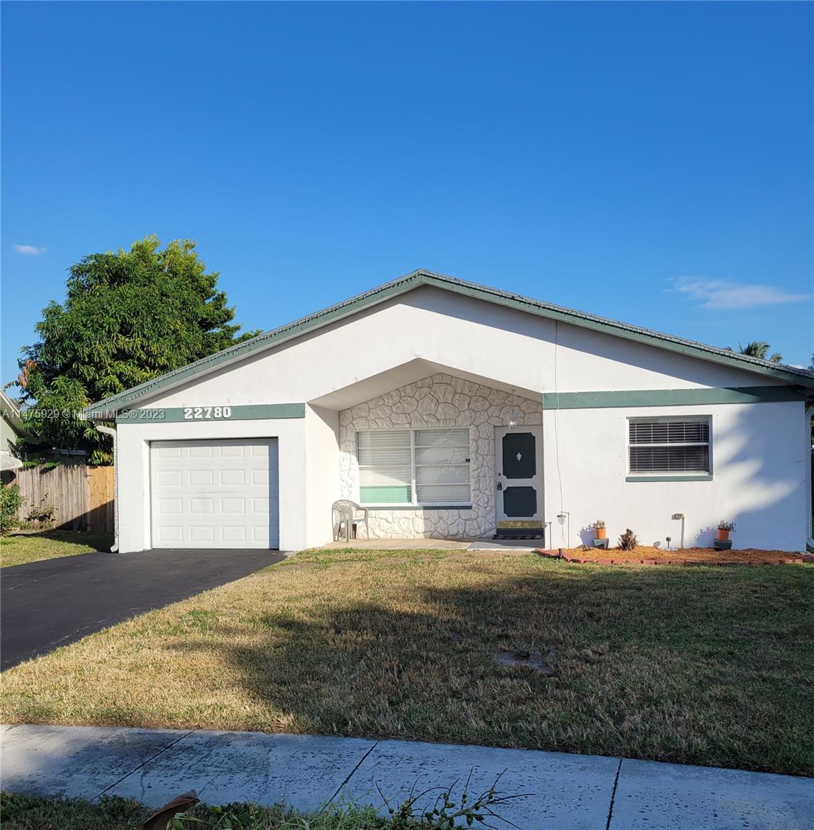 22780 Family Circle Boca Raton, FL 33428 - Photo 1 of 19 a front view of house with yard