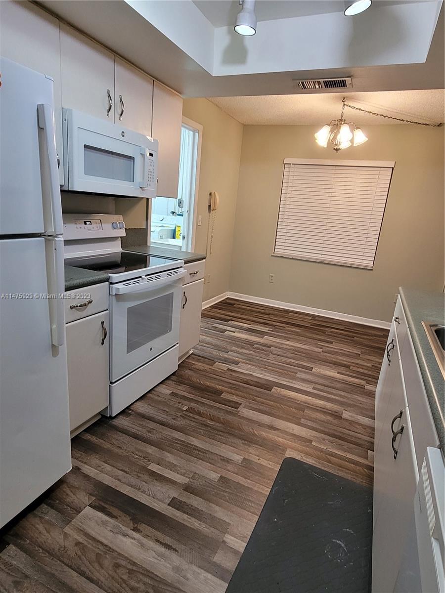 22780 Family Circle Boca Raton, FL 33428 - Photo 11 of 19 a kitchen with stainless steel appliances granite countertop a stove a sink and a refrigerator