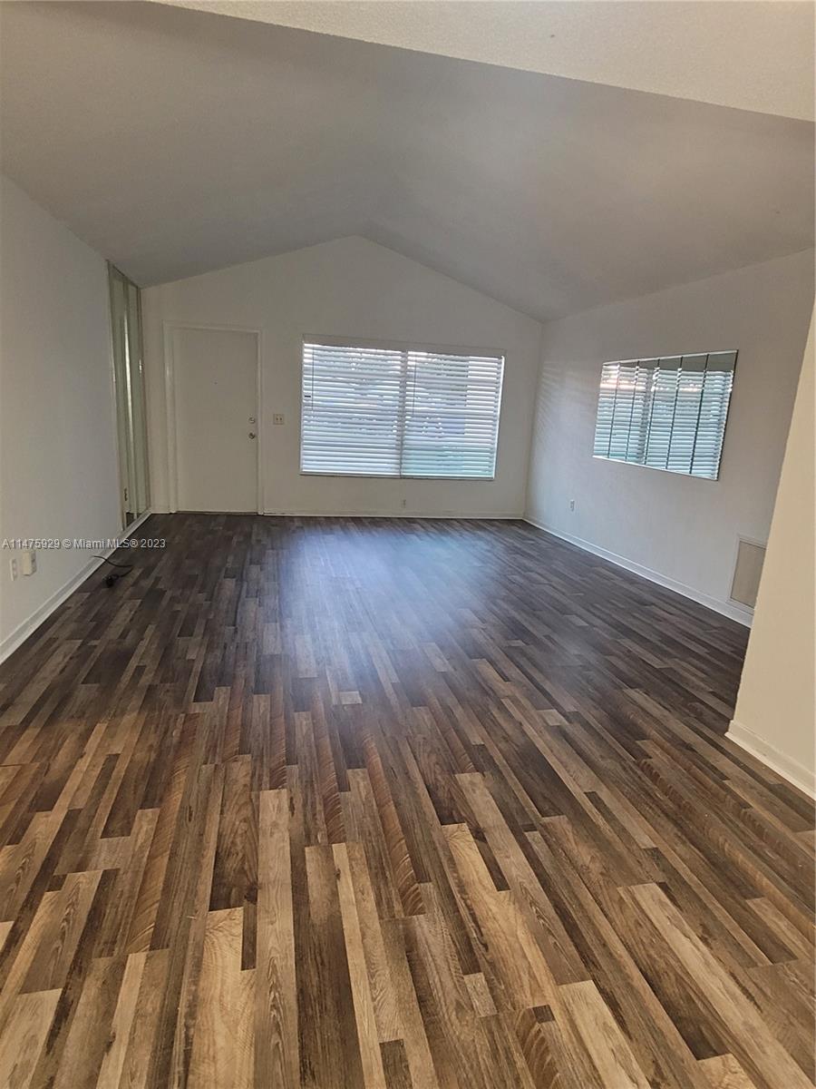 22780 Family Circle Boca Raton, FL 33428 - Photo 18 of 19 an empty room with wooden floor and windows
