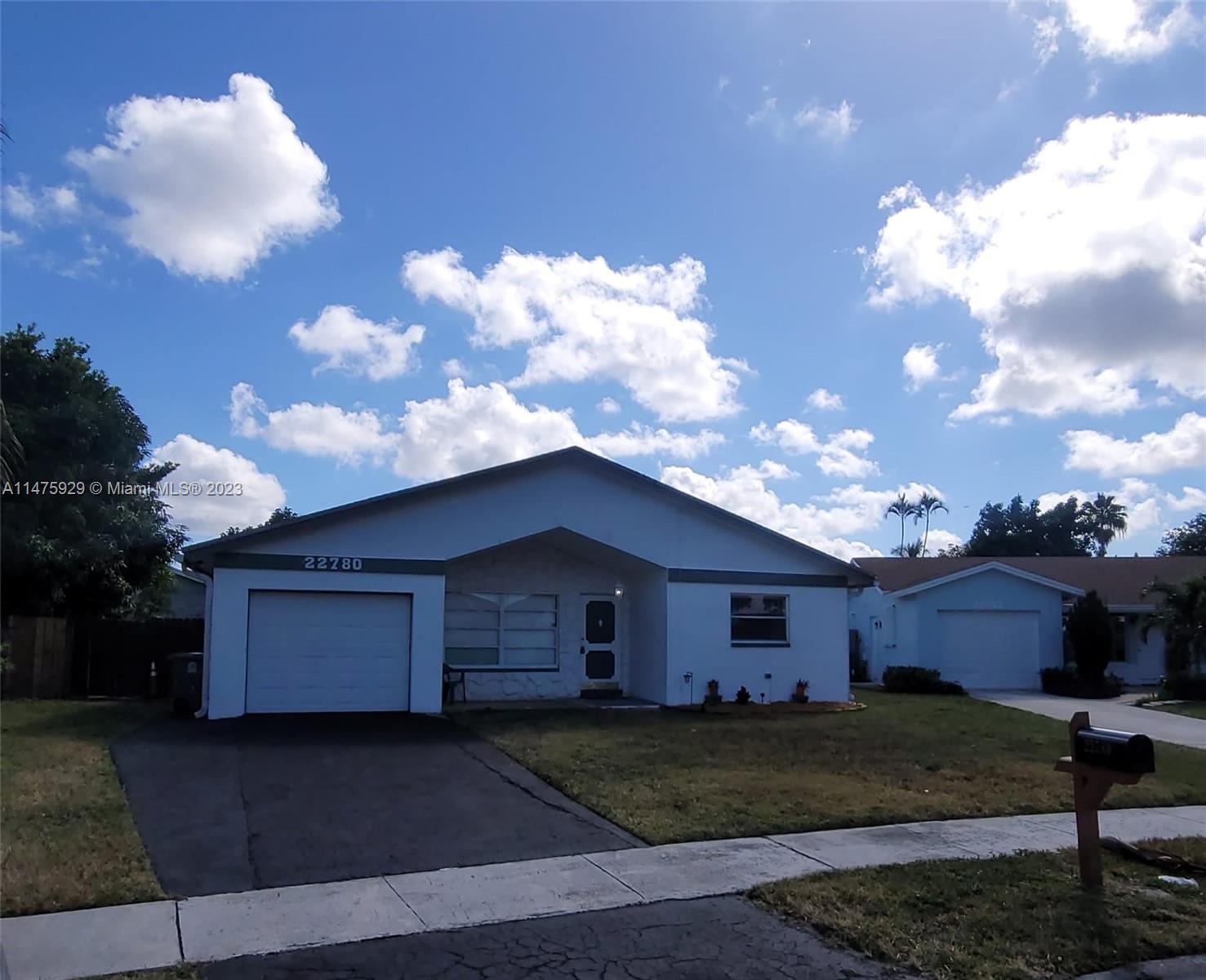 22780 Family Circle Boca Raton, FL 33428 - Photo 2 of 19 a front view of a house with garden