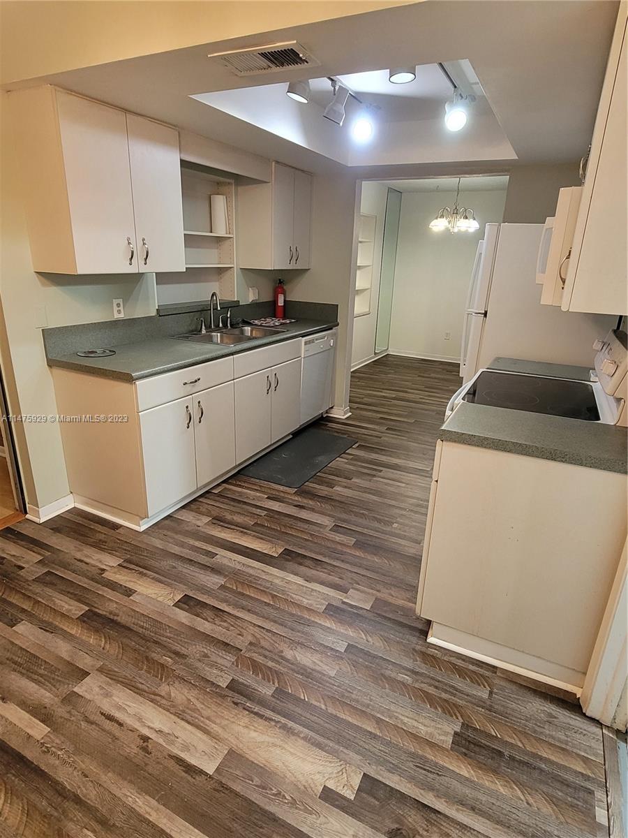 22780 Family Circle Boca Raton, FL 33428 - Photo 10 of 19 a kitchen with stainless steel appliances granite countertop a sink stove and cabinets
