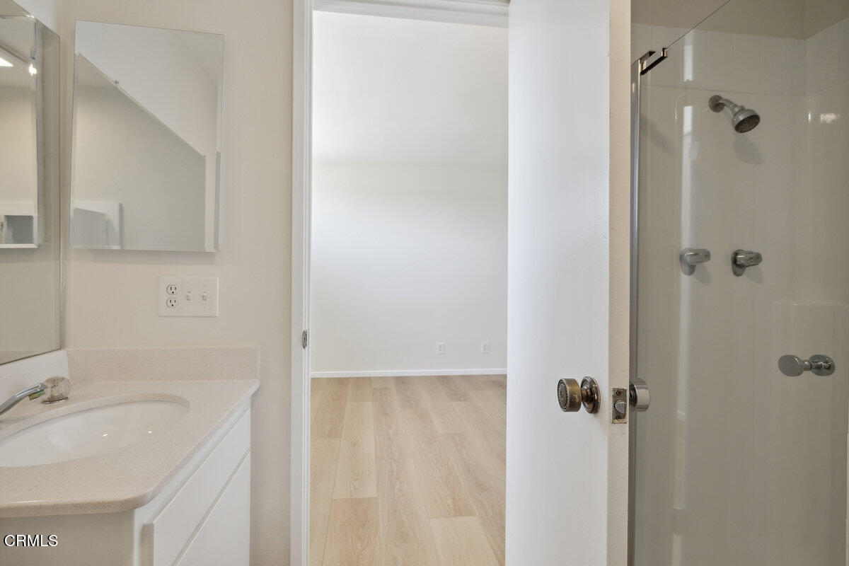 3064 Sunset Lane Oxnard, CA 93035 - Photo 30 of 50 a bathroom with a granite countertop sink and shower