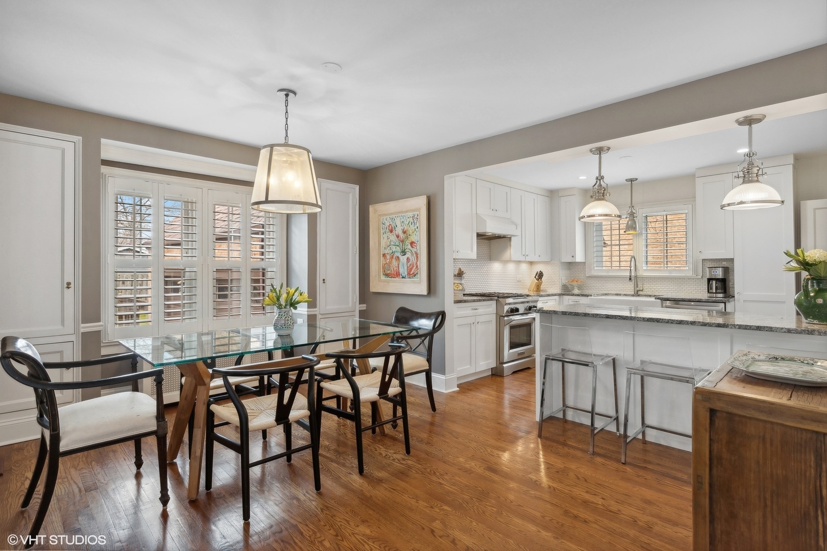 660 Northmoor Road Lake Forest, IL 60045 - Photo 6 of 24 a kitchen with stainless steel appliances granite countertop a stove top oven a sink dishwasher a dining table and chairs with wooden floor