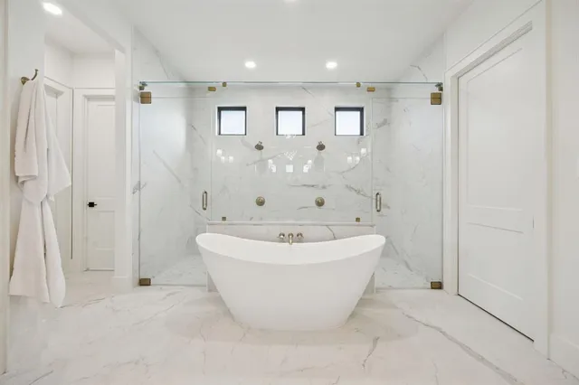a bathroom with a white tub shower