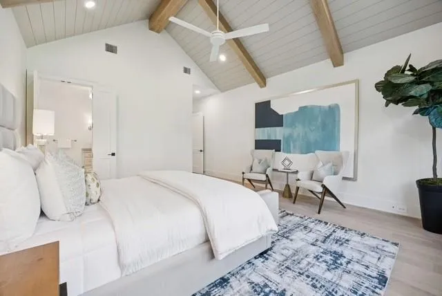 a spacious bedroom with a bed and a dresser