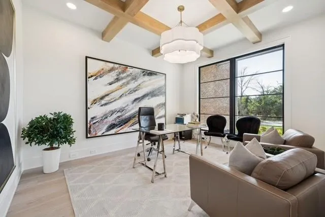 a living room with furniture a chandelier and a large window