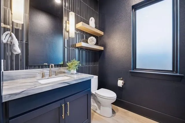 a bathroom with a toilet sink and mirror