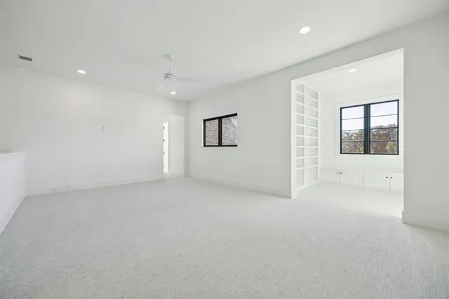 an empty room with windows and closet
