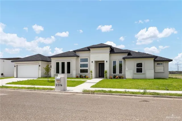 a view of a house with a yard and large trees with a big yard
