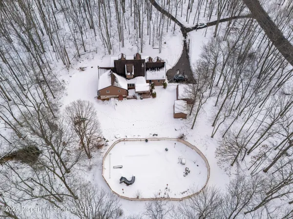 an aerial view of a house with swimming pool