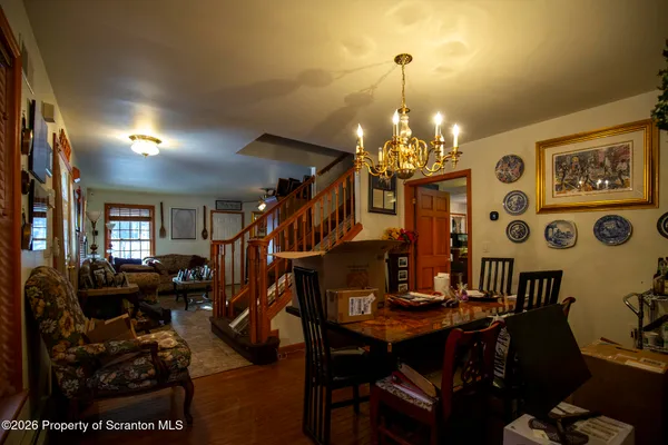 a view of a dining room with furniture and chandelier