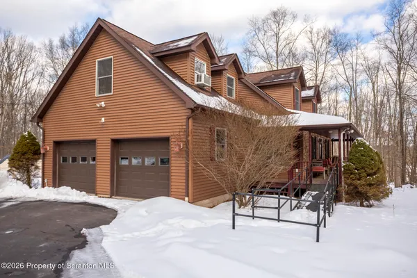 a view of a house with wooden fence