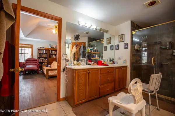 a room with furniture a mirror and a view of living room
