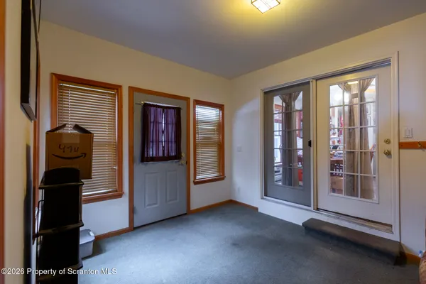 a view of an entryway with wooden floor