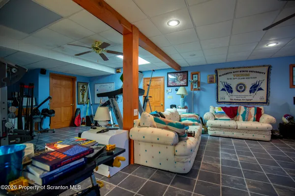 a living room with furniture and a gym