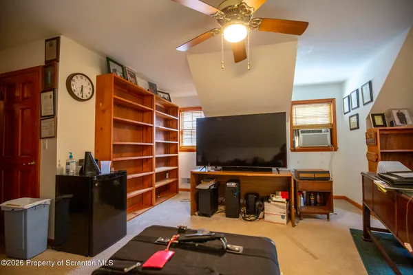 a bedroom with furniture and a flat screen tv