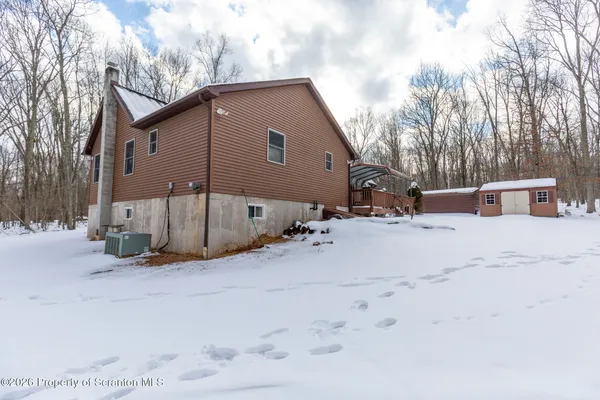 a view of a house with a snow in the yard