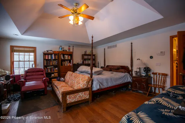 a bedroom with a bed couch and a window