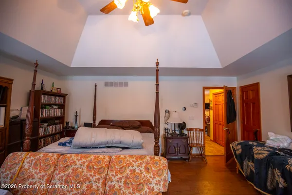 a bedroom with a bed furniture and a large window