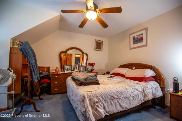 a bedroom with bed and a chandelier
