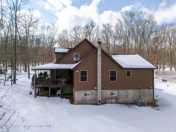 a view of a house with a yard and sitting area