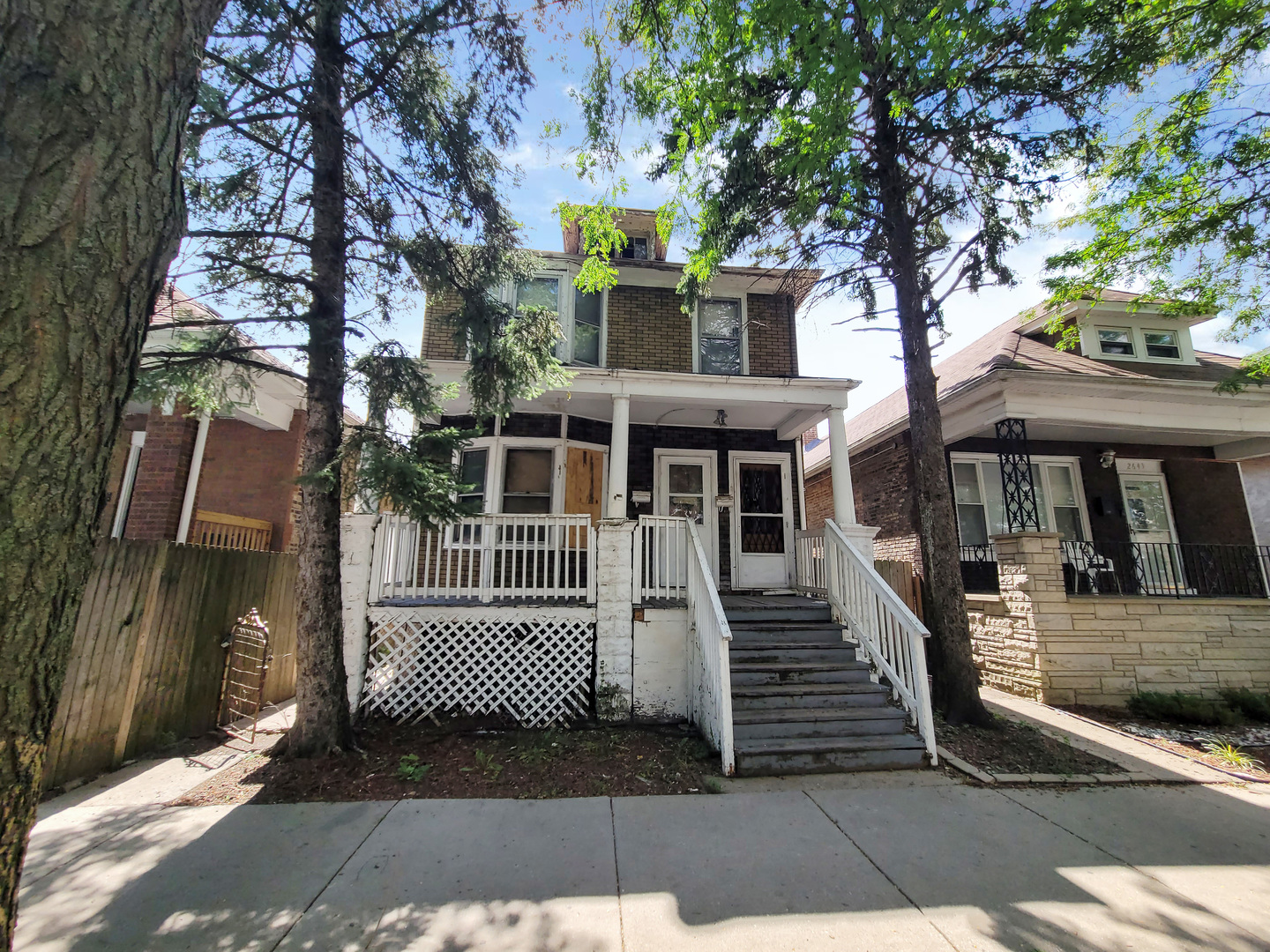 2641 West 69th Street Chicago, IL 60629 - Photo 2 of 16 a view of a brick house with large windows and a small yard