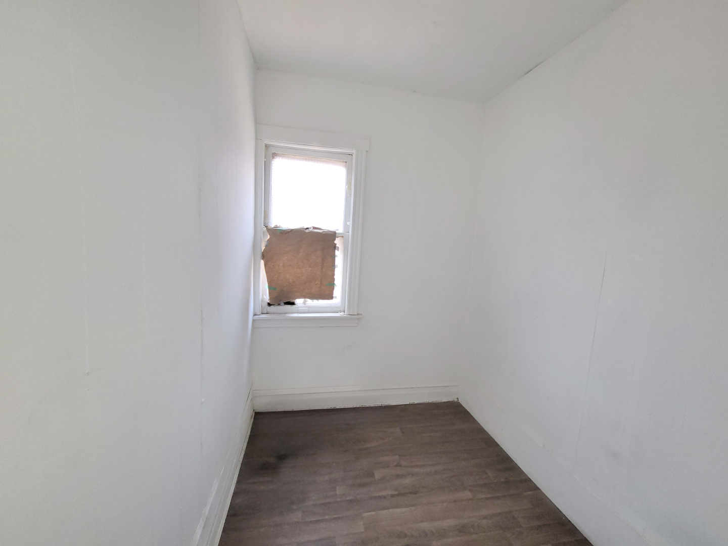 2641 West 69th Street Chicago, IL 60629 - Photo 5 of 16 a view of an empty room with wooden floor and a window