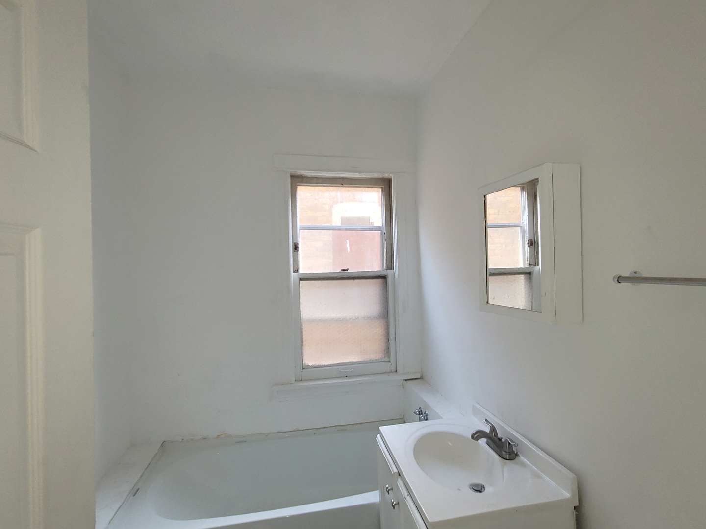 2641 West 69th Street Chicago, IL 60629 - Photo 6 of 16 a bathroom with a sink and a window