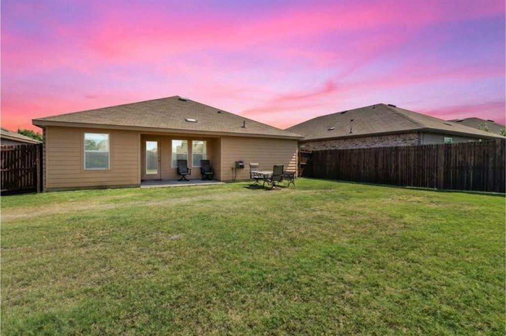 409 Wilson Way Denton, TX 76207 - Photo 24 of 33 Expansive backyard featuring a manicured lawn and a private wood fence