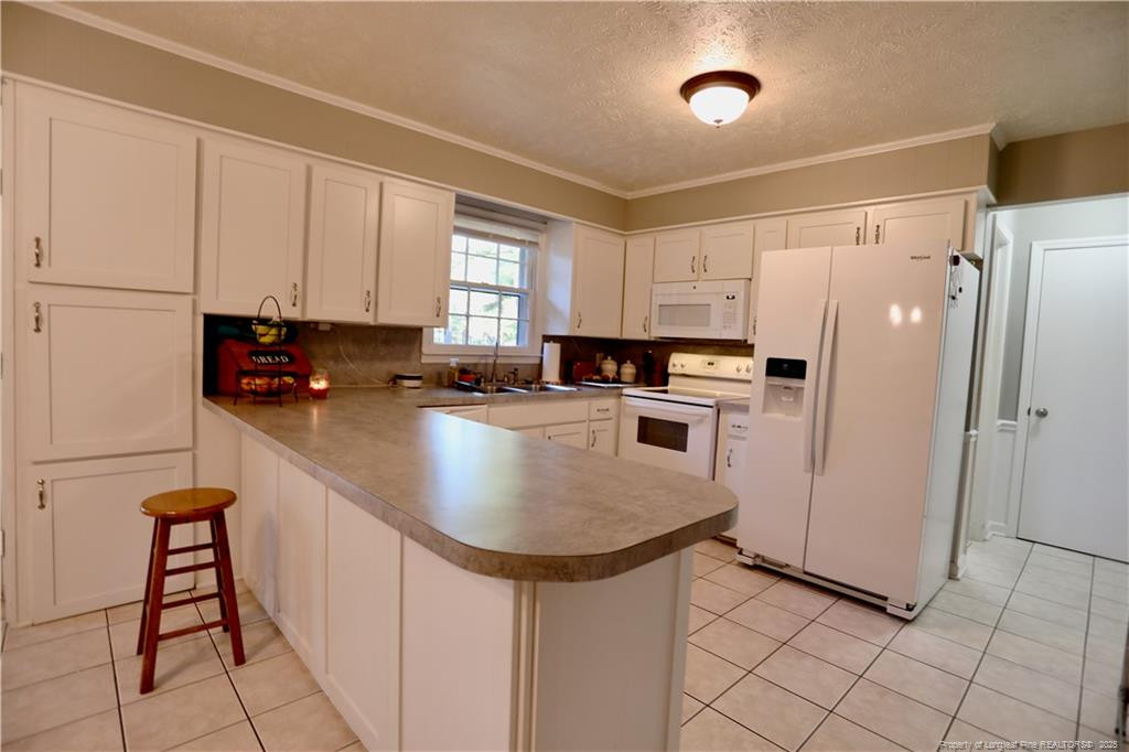 948 Pinebluff Lake Road Aberdeen, NC 28315 - Photo 11 of 32 a kitchen with stainless steel appliances a refrigerator sink and cabinets