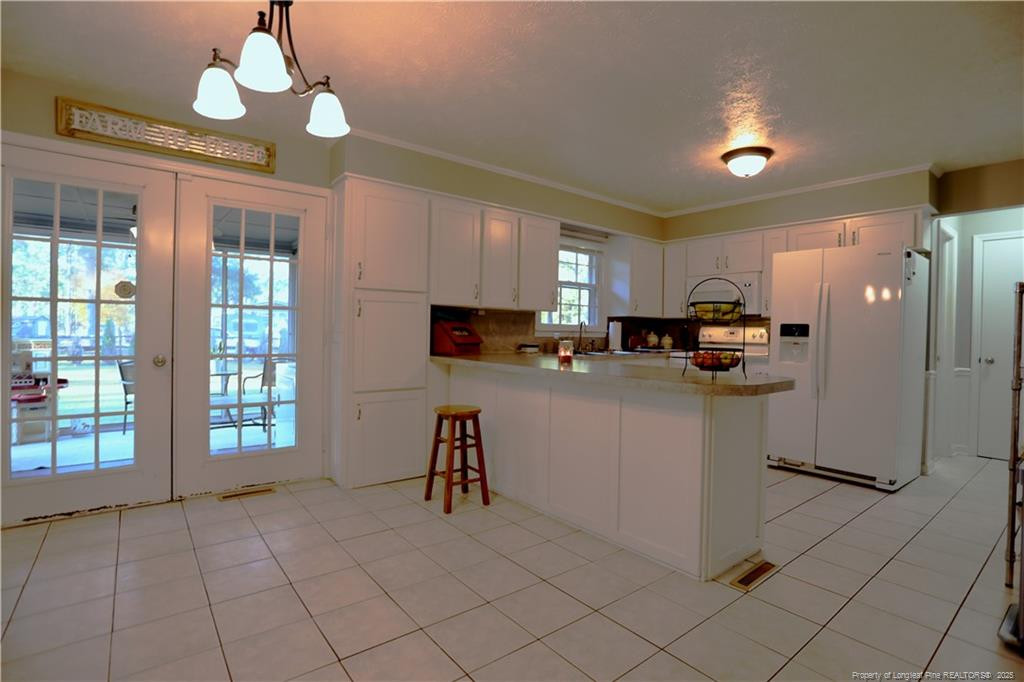 948 Pinebluff Lake Road Aberdeen, NC 28315 - Photo 13 of 32 a kitchen with cabinets and a refrigerator