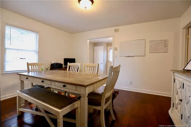 a dining room with furniture and wooden floor