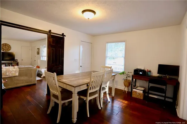 a view of a dining room with furniture and wooden floor