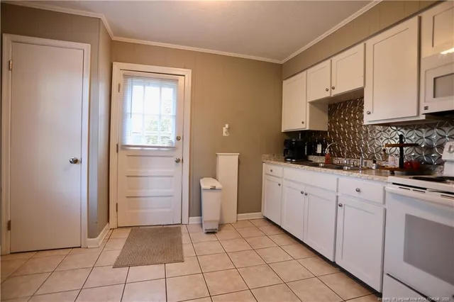 a kitchen with white cabinets and white appliances