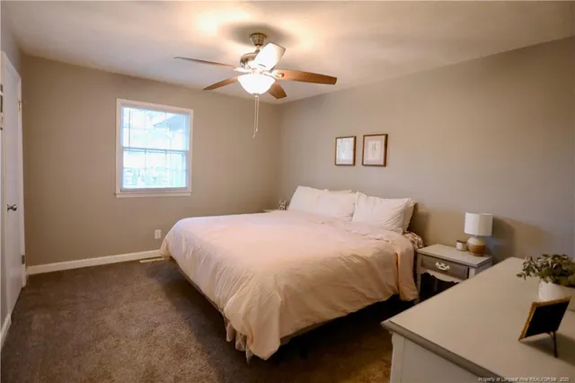 a bedroom with bed and window