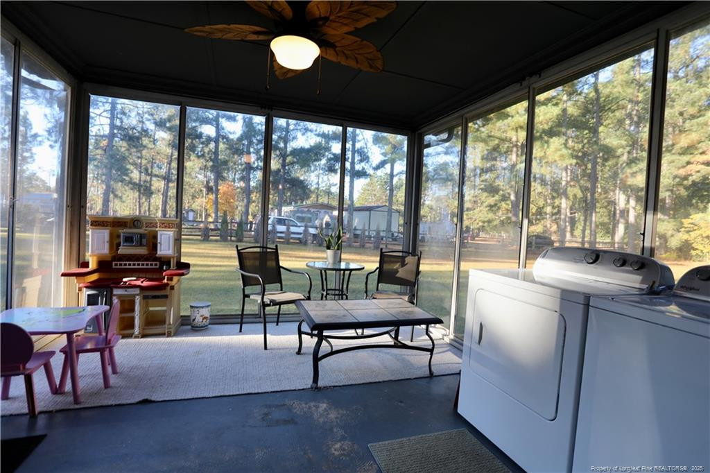 948 Pinebluff Lake Road Aberdeen, NC 28315 - Photo 28 of 32 a living room with furniture and a floor to ceiling window