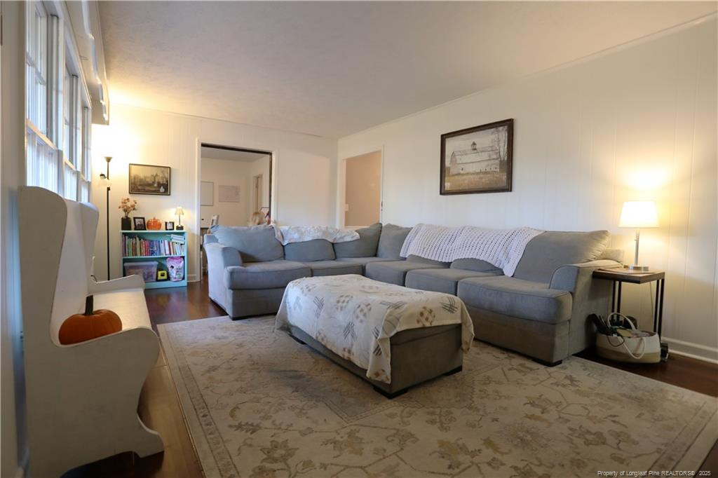 948 Pinebluff Lake Road Aberdeen, NC 28315 - Photo 7 of 32 a living room with furniture a lamp and a large window