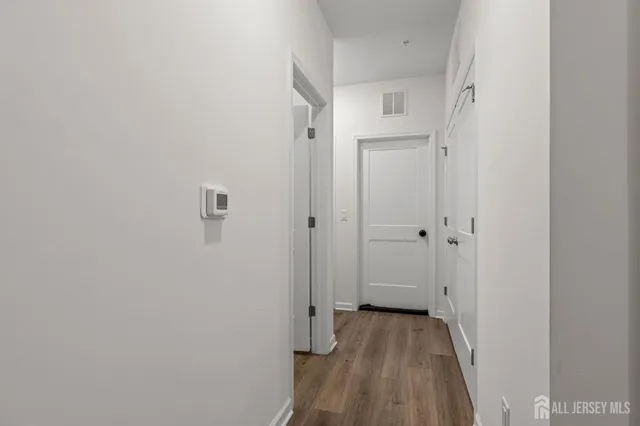 a view of a room with wooden floor