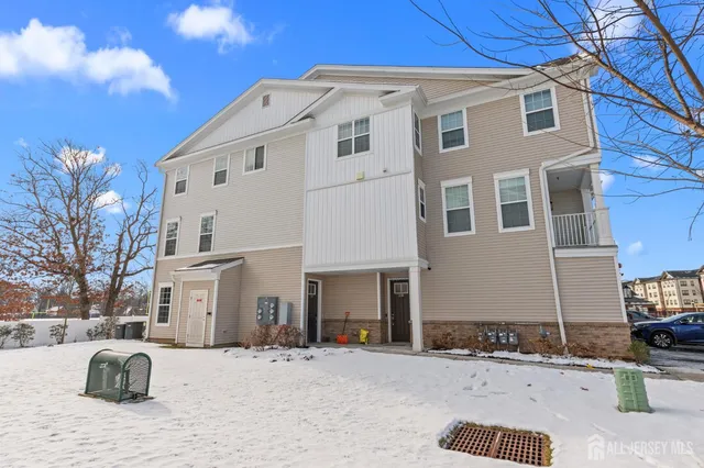 a large white building with a yard in front of it